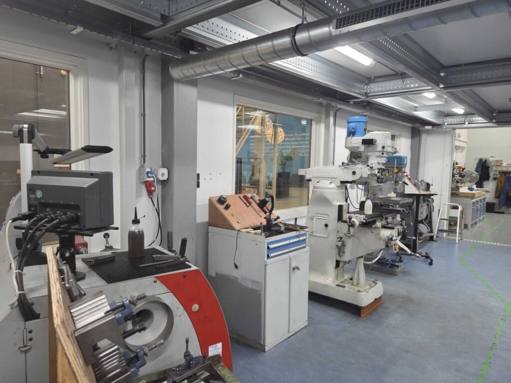 Overview of Fantomiq’s workplace showing various machines, tools, and workstations used for precision fabrication.